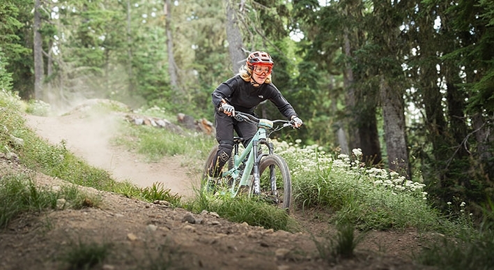 FEMALE MOUNTAIN BIKER SHREDDING DIRT AT TIMBERLINE BIKE PARK