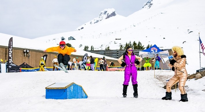 Two drag queen cheering on a skier at Timberline for OpenSlopes PDX Spring Sesh Rail Jam