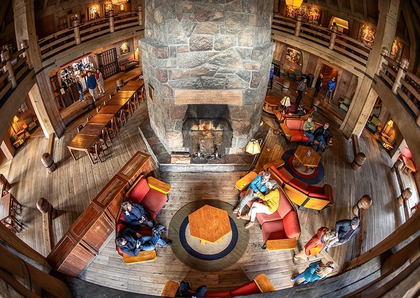 TIMBERLINE MAIN HEADHOUSE FIREPLACE AND CHIMNEY WITH FOLKS GATHERED AROUND