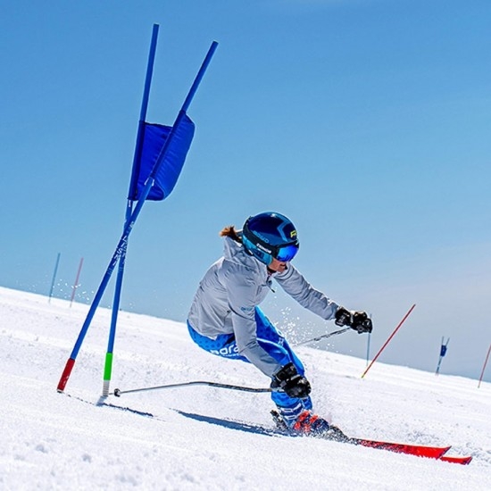 ADULT MASTERS CAMPER ROUNDING A FLAG AT TIMBERLINE SUMMER SNOW CAMP