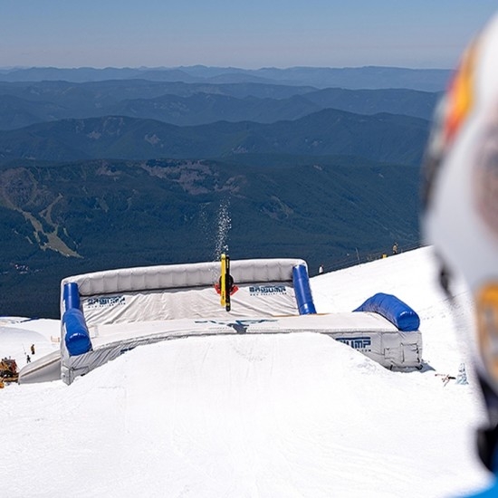 FREESTYLE SKIER LANDING IN THE AIR BAG AT TIMBERLINE SUMMER SNOW CAMP