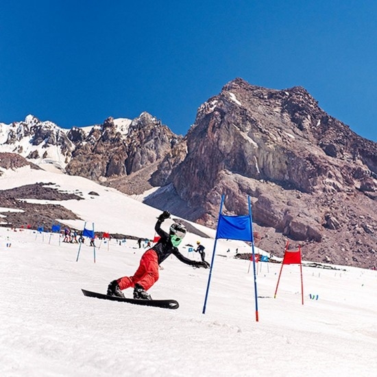 YOUTH PERFORMANCE SNOWBOARDER TAKING TURNS AT TIMBERLINE SUMMER SNOW CAMP