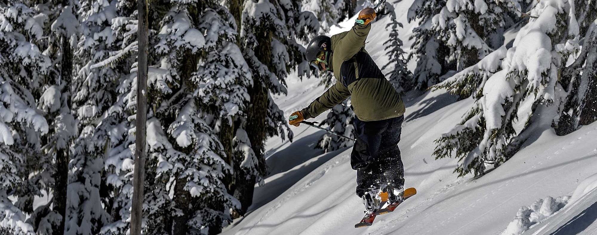 SKIER JUMPING THROUGH THE TREES AT TIMBERLINE