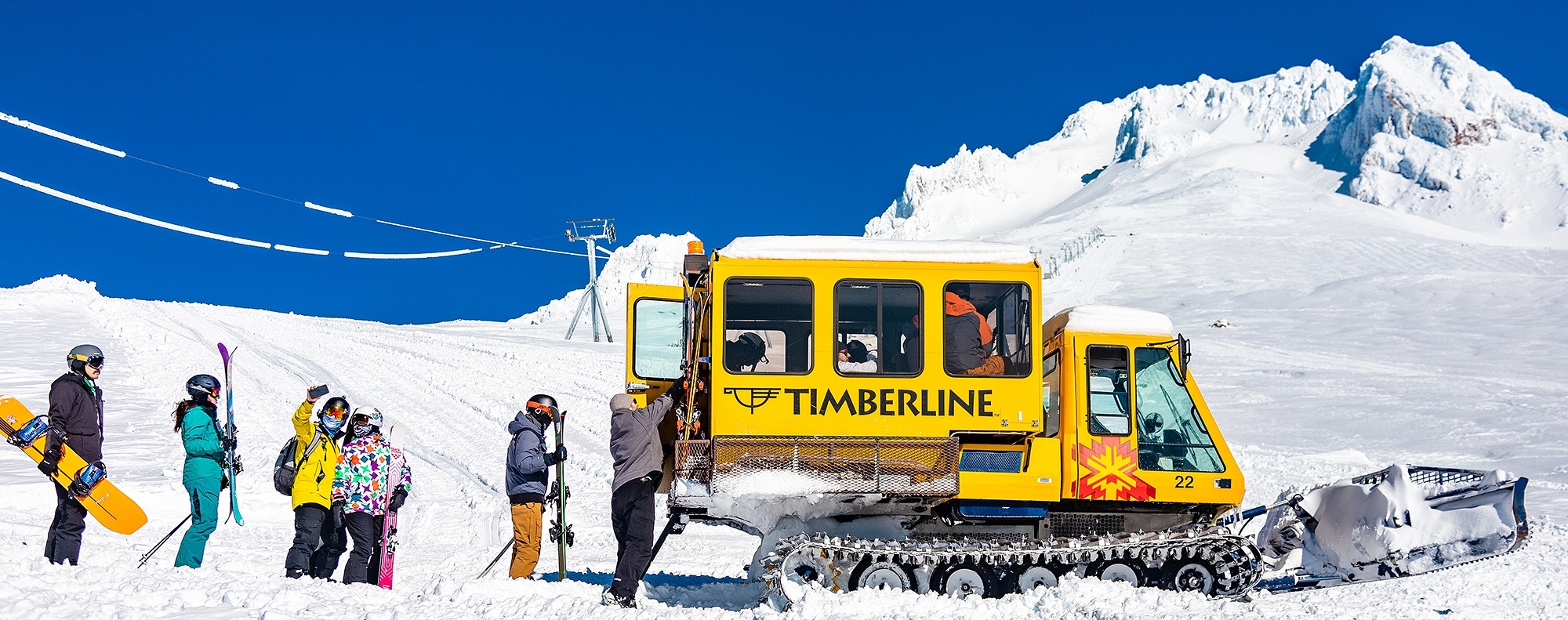 Timberline's yellow snowcat loading up skiers and snowboarders for Palmer Cat Ski on Mt. Hood