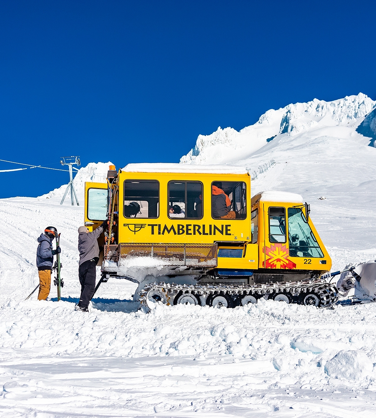 Timberline's yellow snowcat loading up skiers and snowboarders for Palmer Cat Ski on Mt. Hood