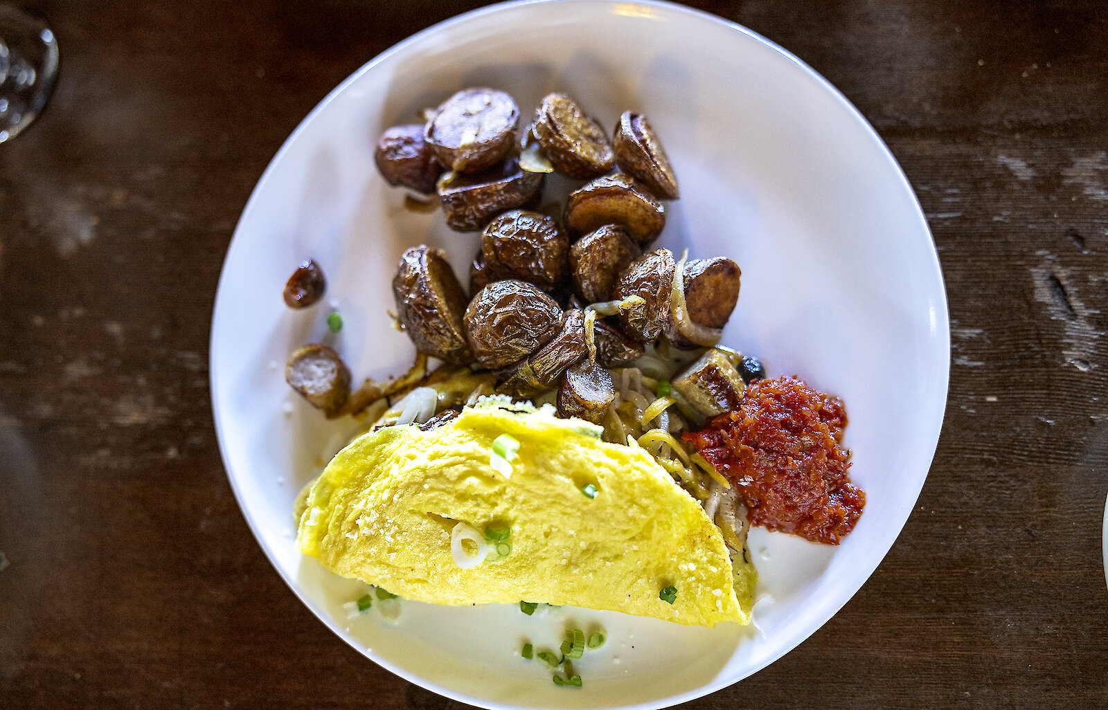 Omelet and roasted potatoes with a side of salsa on a white plate in the Cascade Dining Room at Timberline