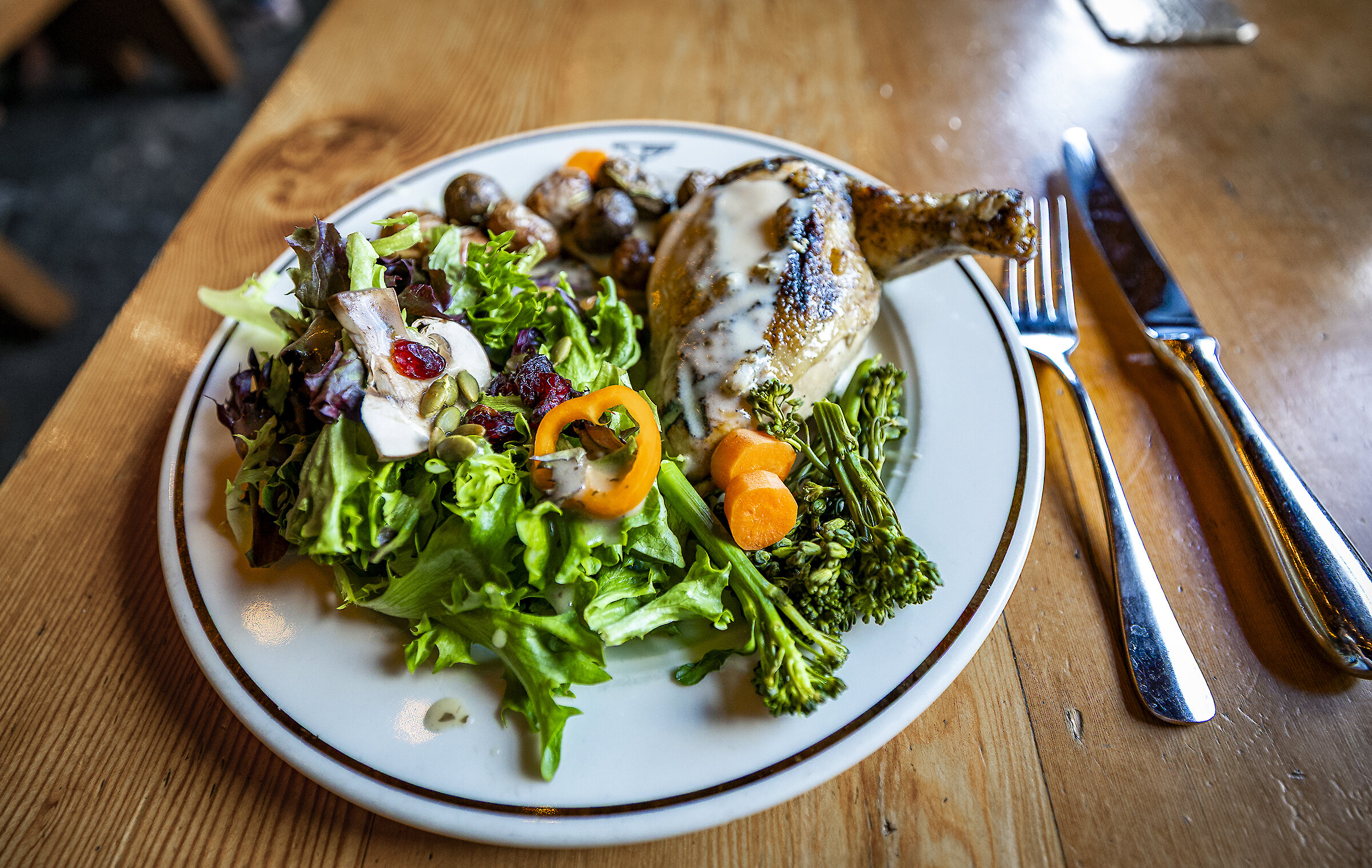 A dinner plate of roast chicken, salad, and potatoes at Silcox Hut