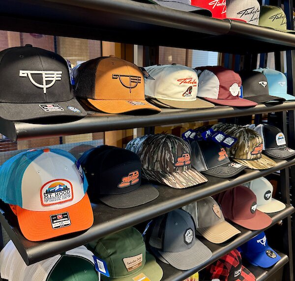 Wall of Timberline logo hats in the Wy'EAst Store