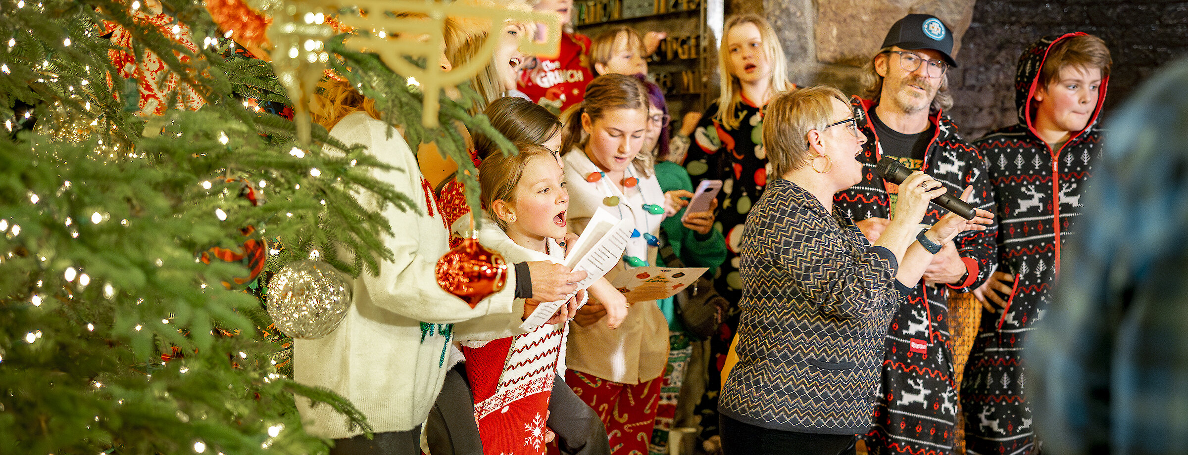 Timberline guests singing Christmas carols by the Christmas tree