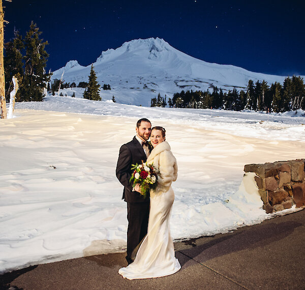 Groom and bride pictured at Timberline in front of Mt. Hood