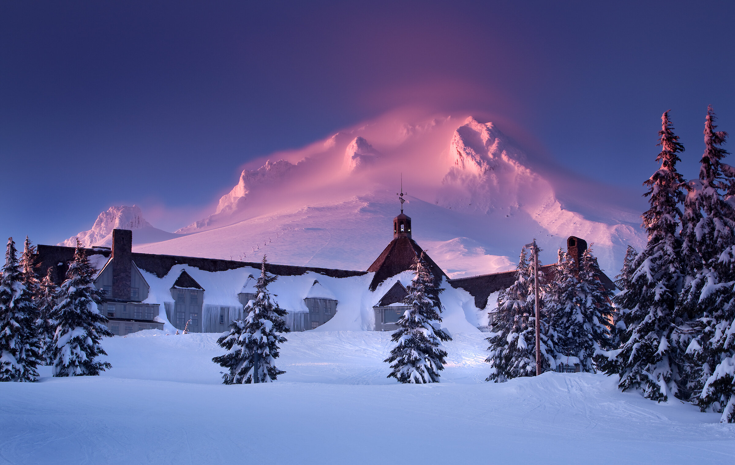 Winter sunrise at Timberline Lodge with Mount Hood glowing pink.
