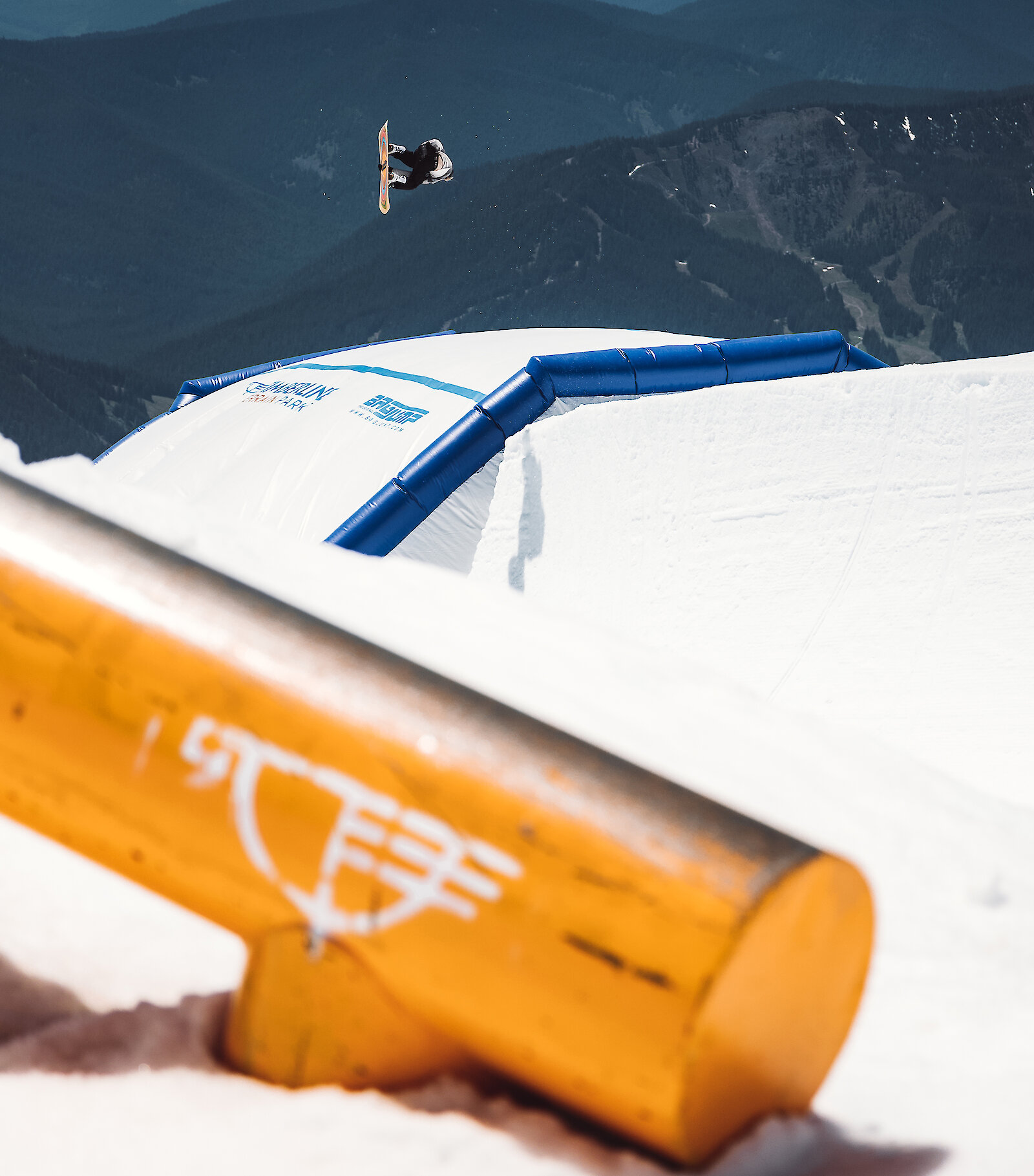 Snowboarder launches above the airbag at the Timberline Freestyle Training Center on Mount Hood