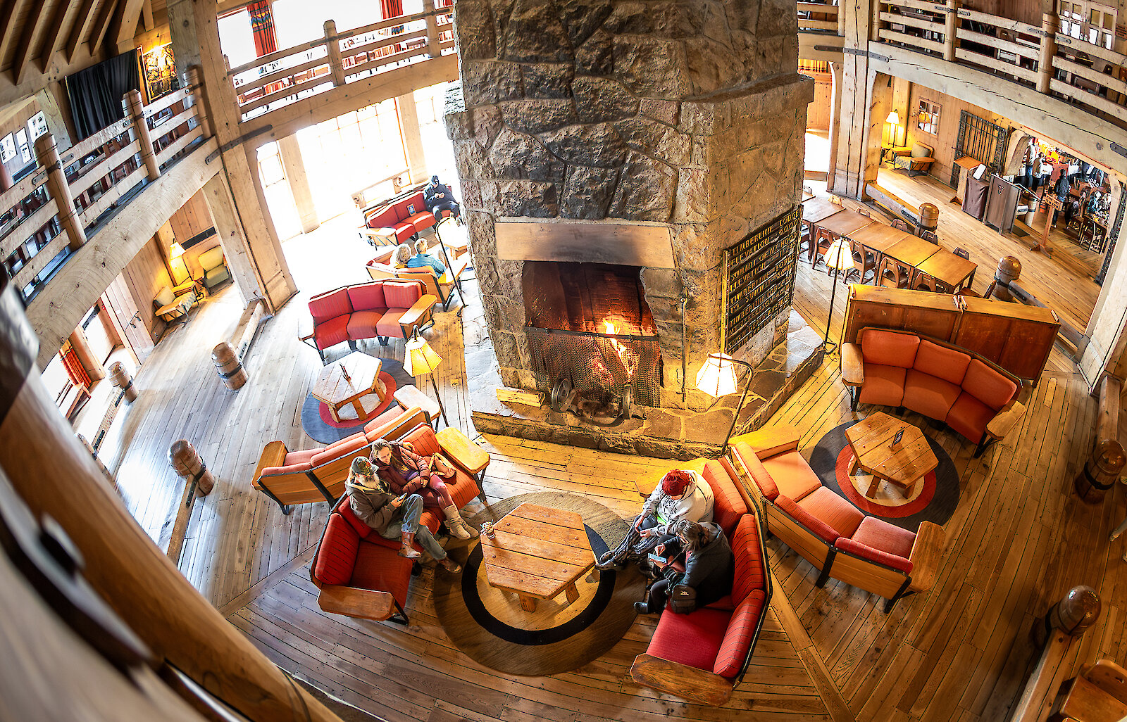 Folks sitting in couches around the massive fireplace in Timberline' Headhouse.