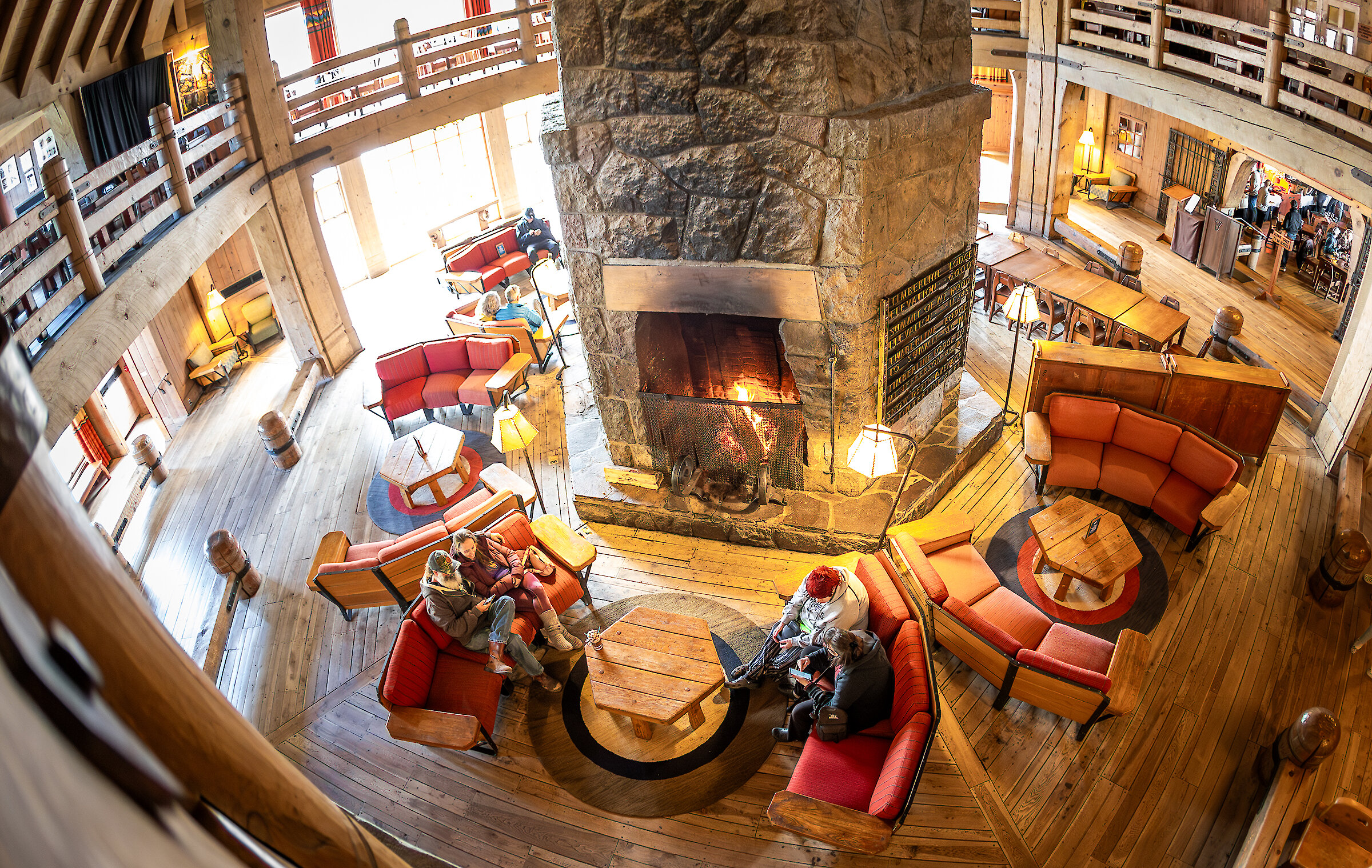 Folks sitting in couches around the massive fireplace in Timberline' Headhouse.