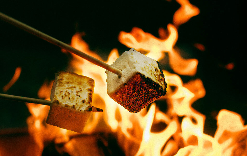 Square marshmallows being roasted over open flame