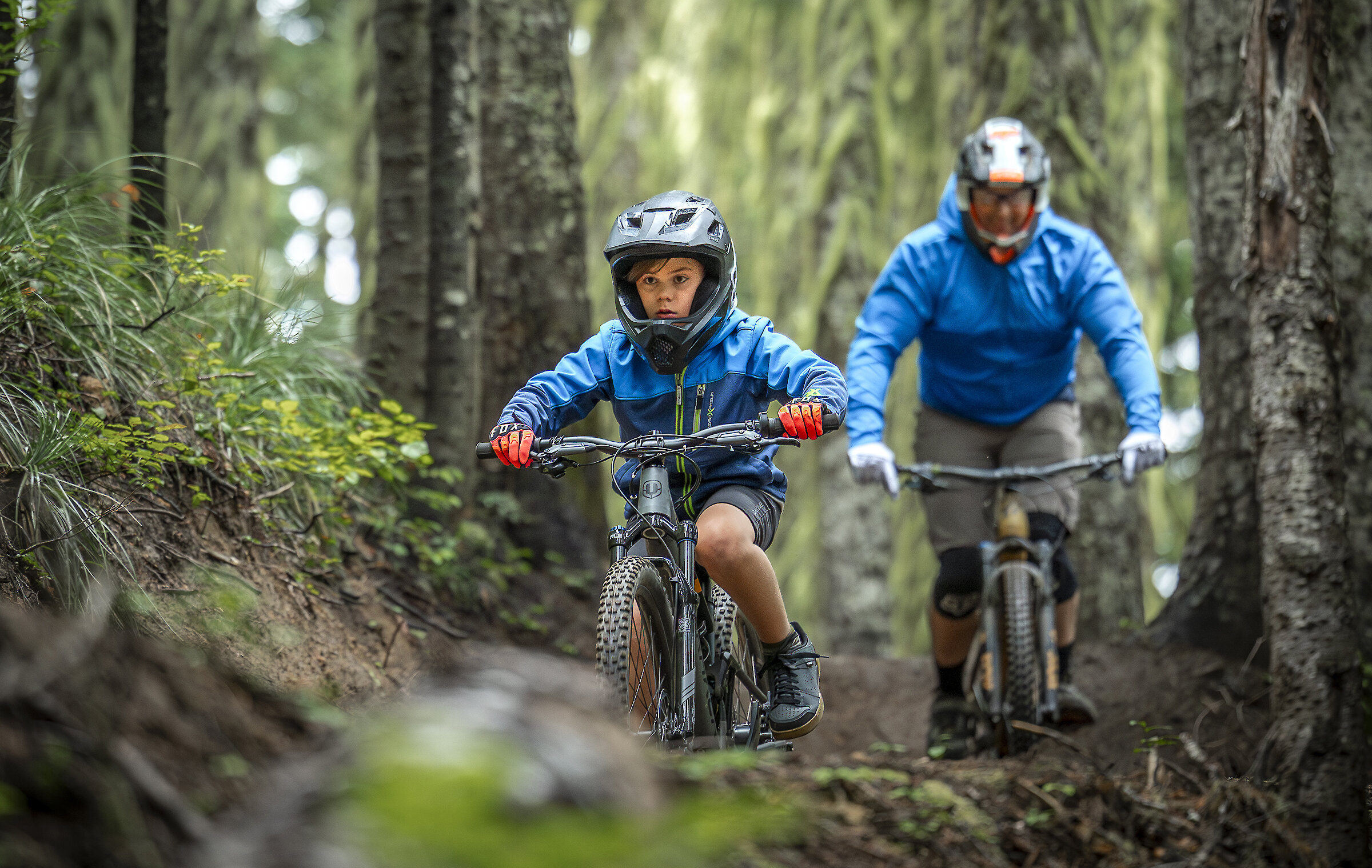 Dad and son riding mountain bikes in the Timberline Bike Park