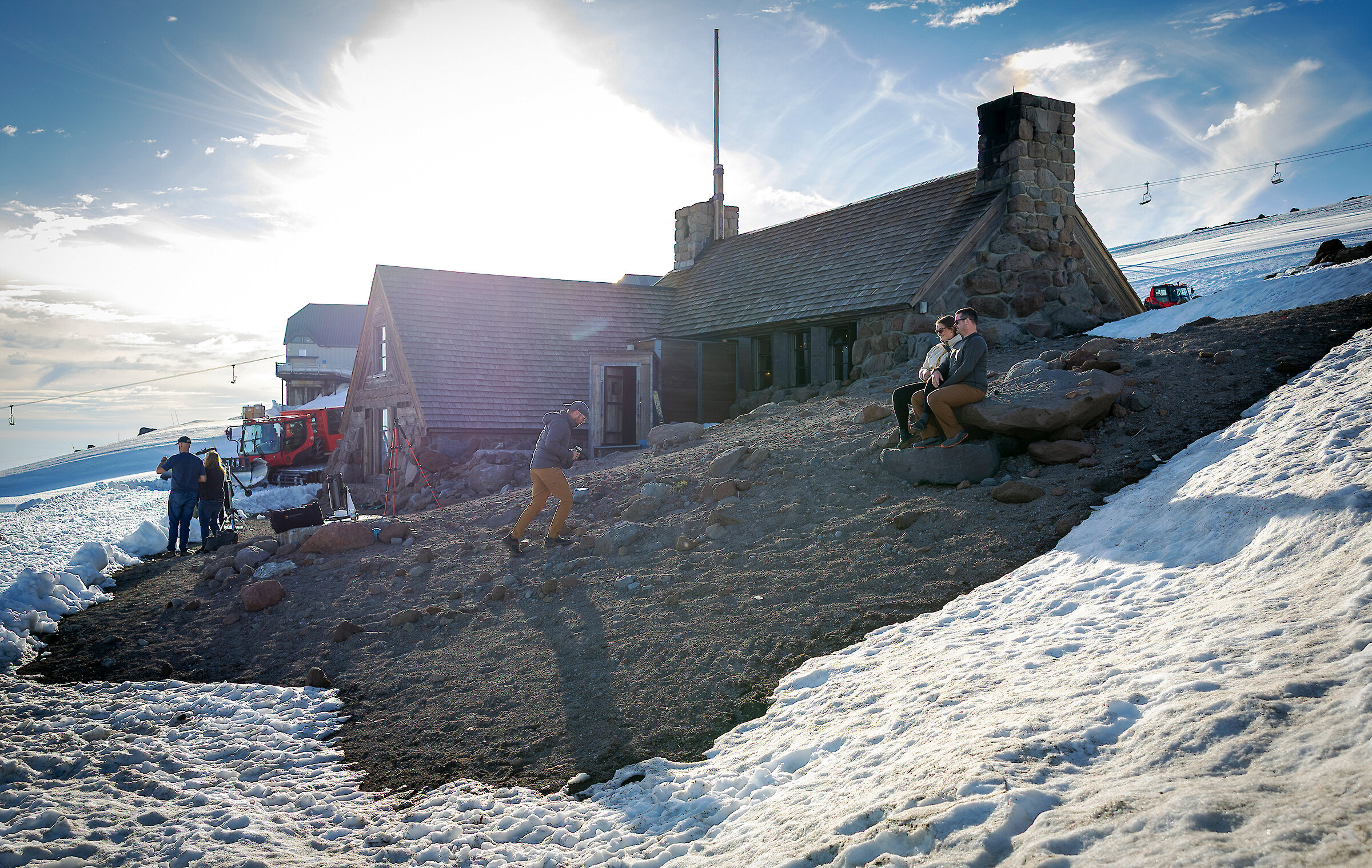 Guests walking around the exterior of Silcox Hut in late spring