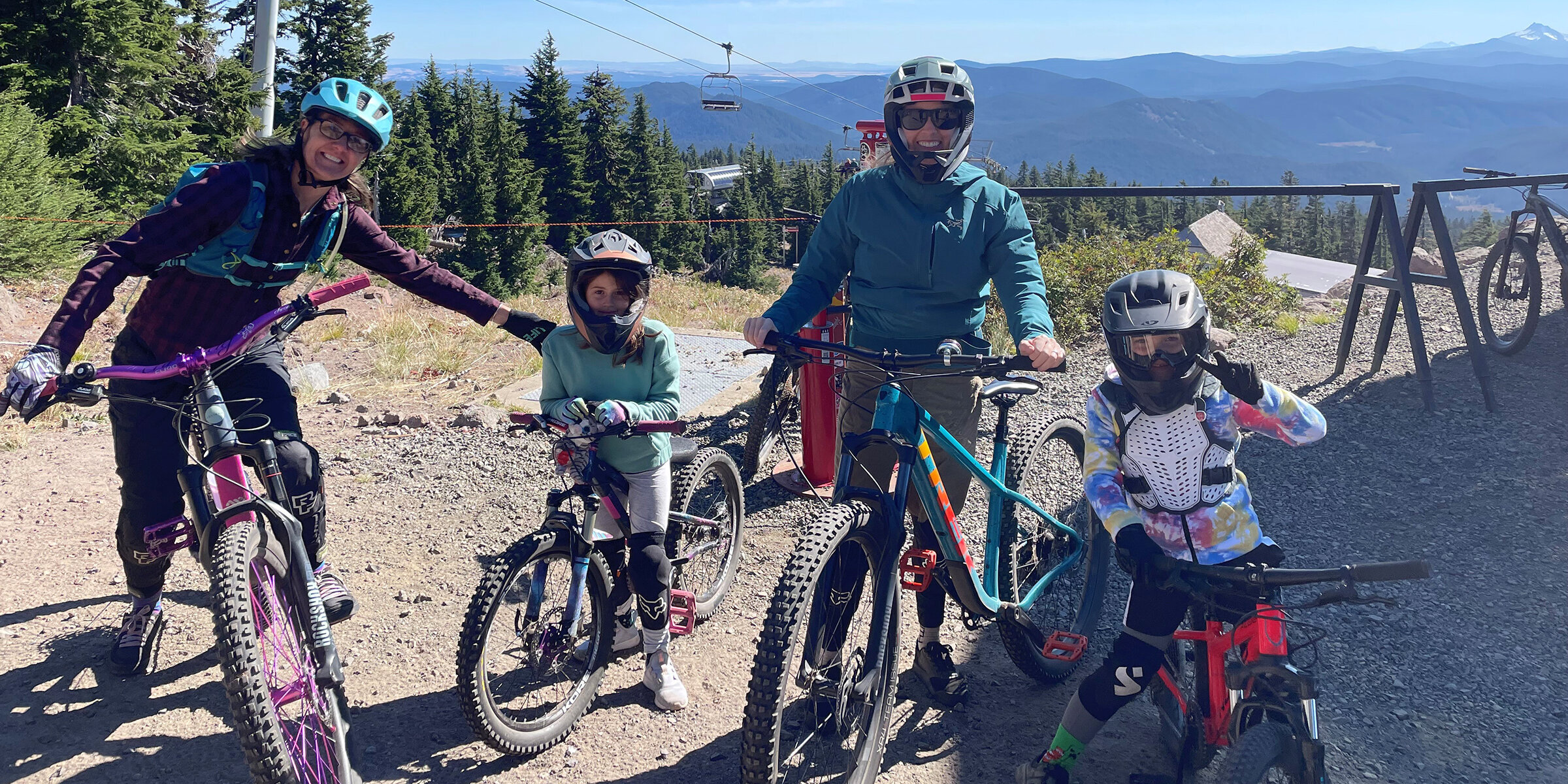 Two moms and two kids on mountain bikes at the Timberline Bike Park