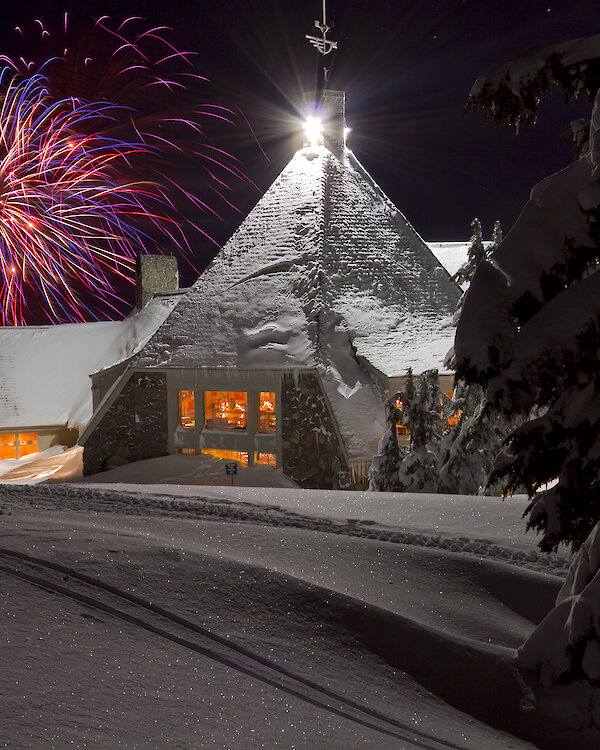 Fireworks going off in the snow at Timberline Lodge during New Year's Eve