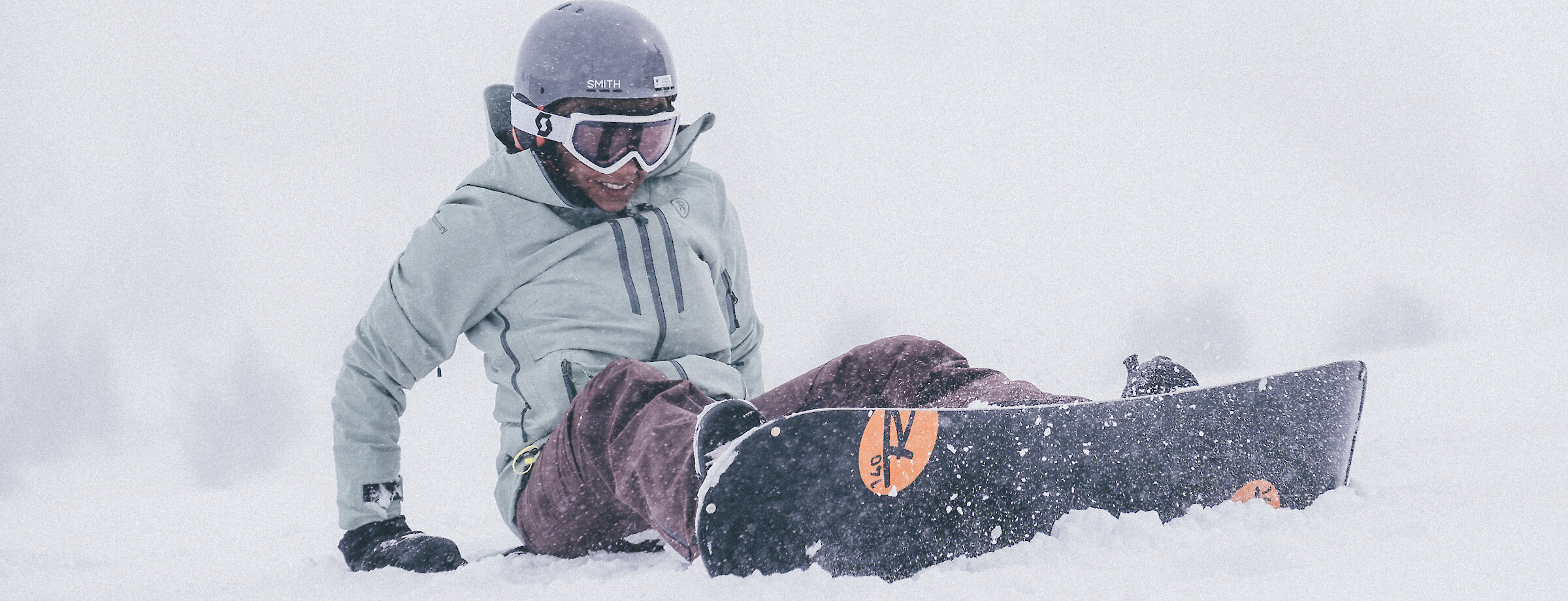 Snowboarder in rental gear in the snow at Timberline