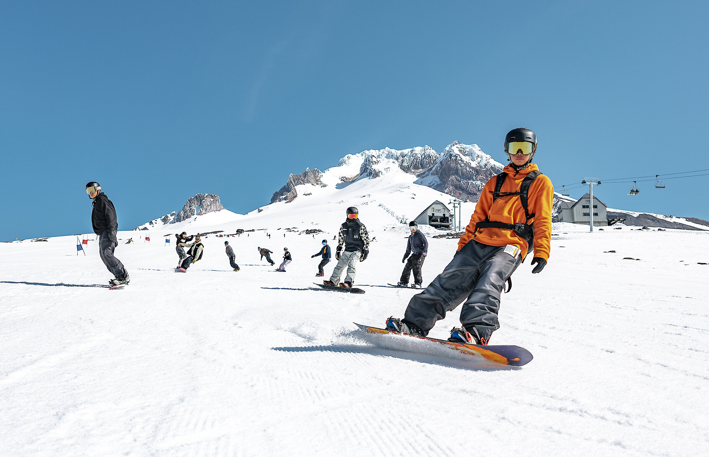 Snowboarders riding down Mt. Hood at Timberline for spring pass