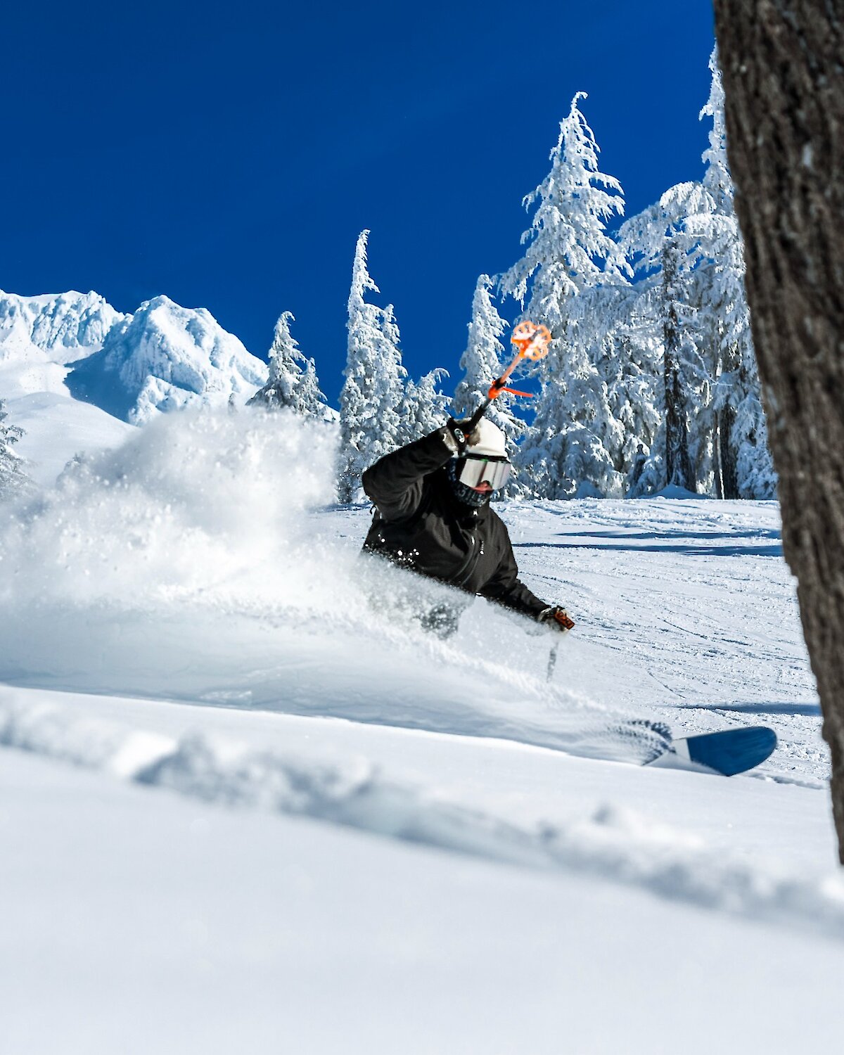Skier slashing through the snow at Timberline on Mt. Hood