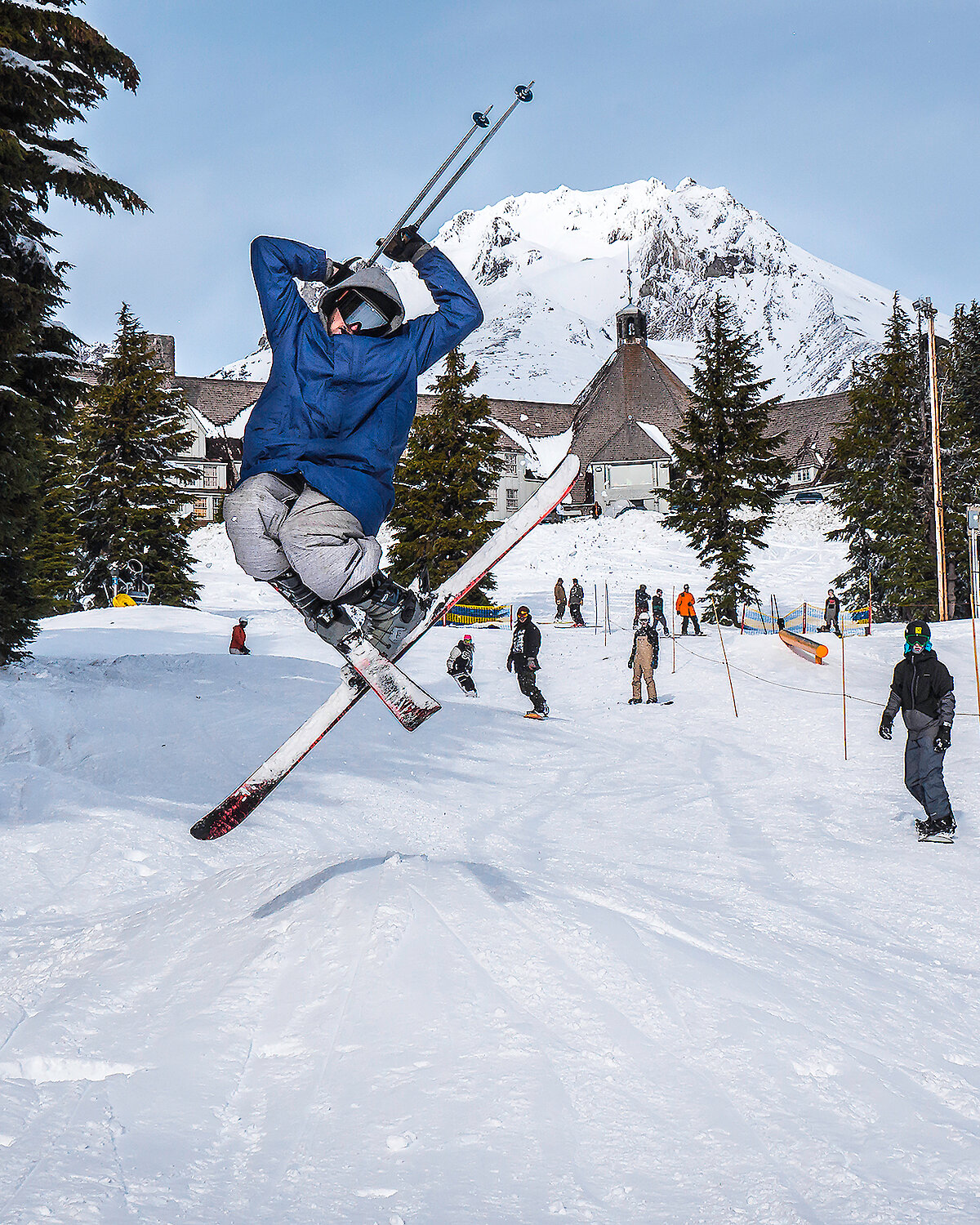 Skier jumping for joy in front of Timberline and Mt. Hood