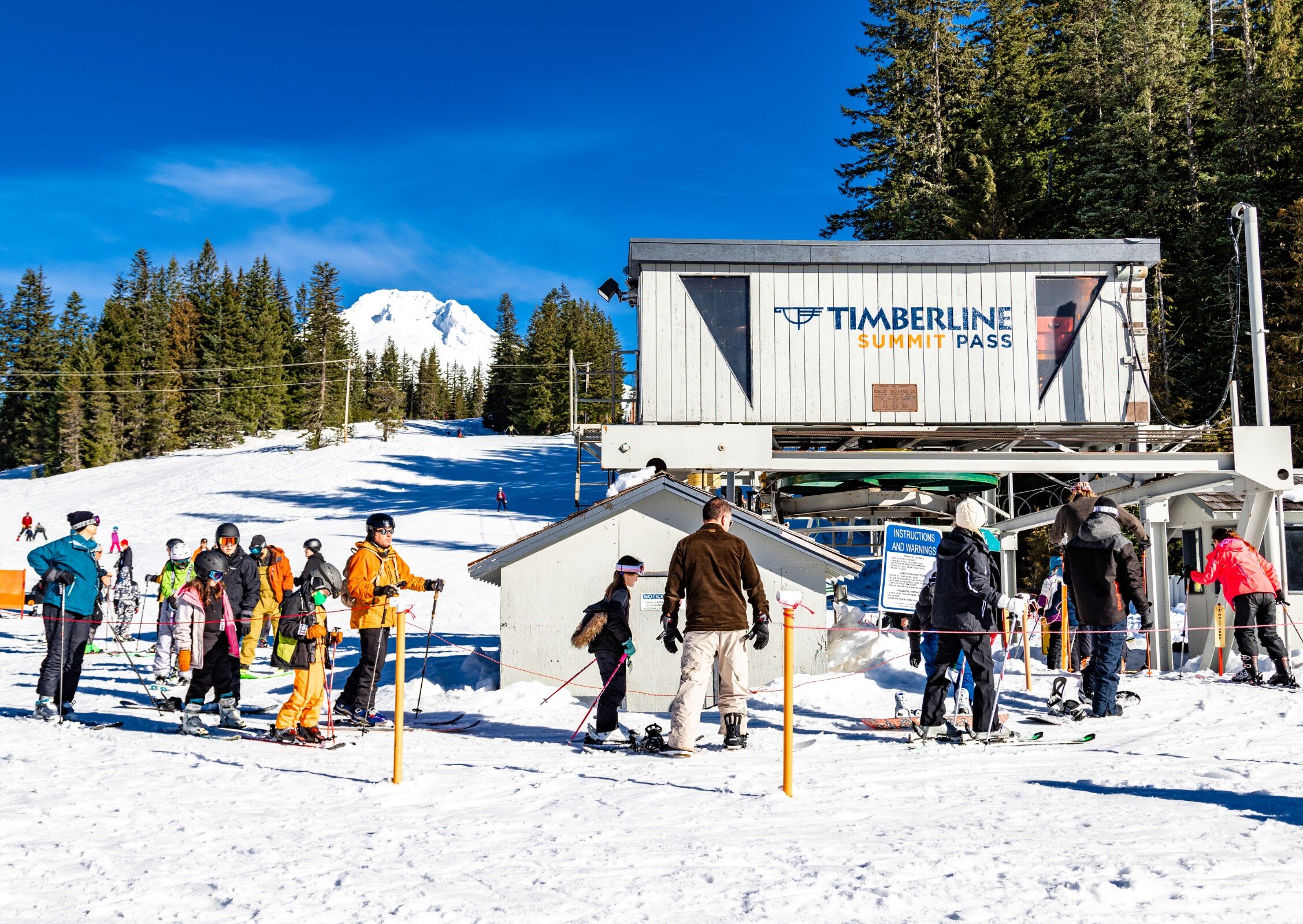 Skiers and snowboarders entering the lift line at Timberline Summit Pass
