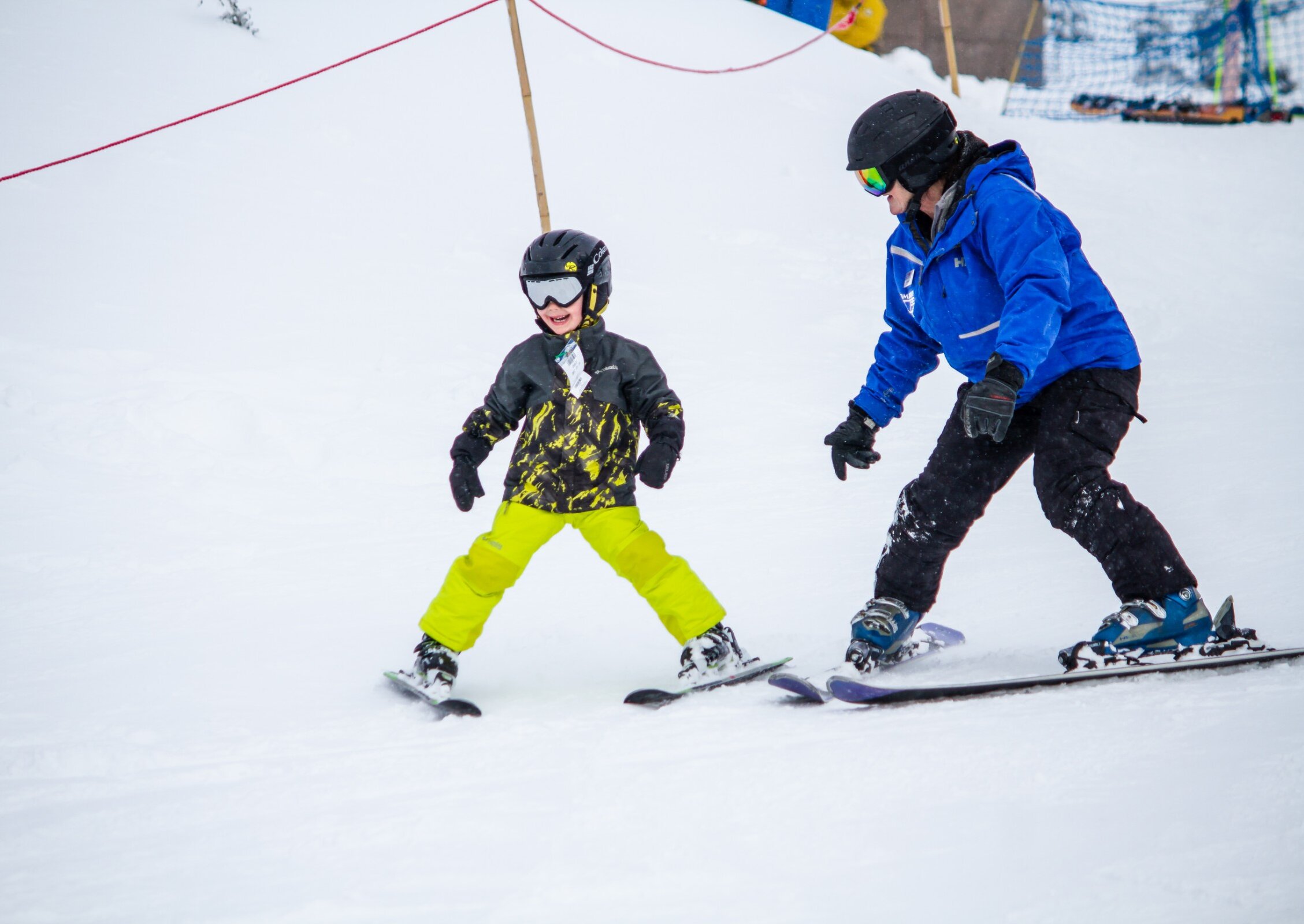 A Timberline ski instructor teaching a young skier