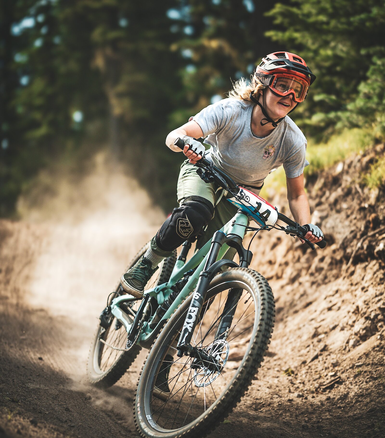 Female mountain biker coming around a curve at the Timberline Bike Park