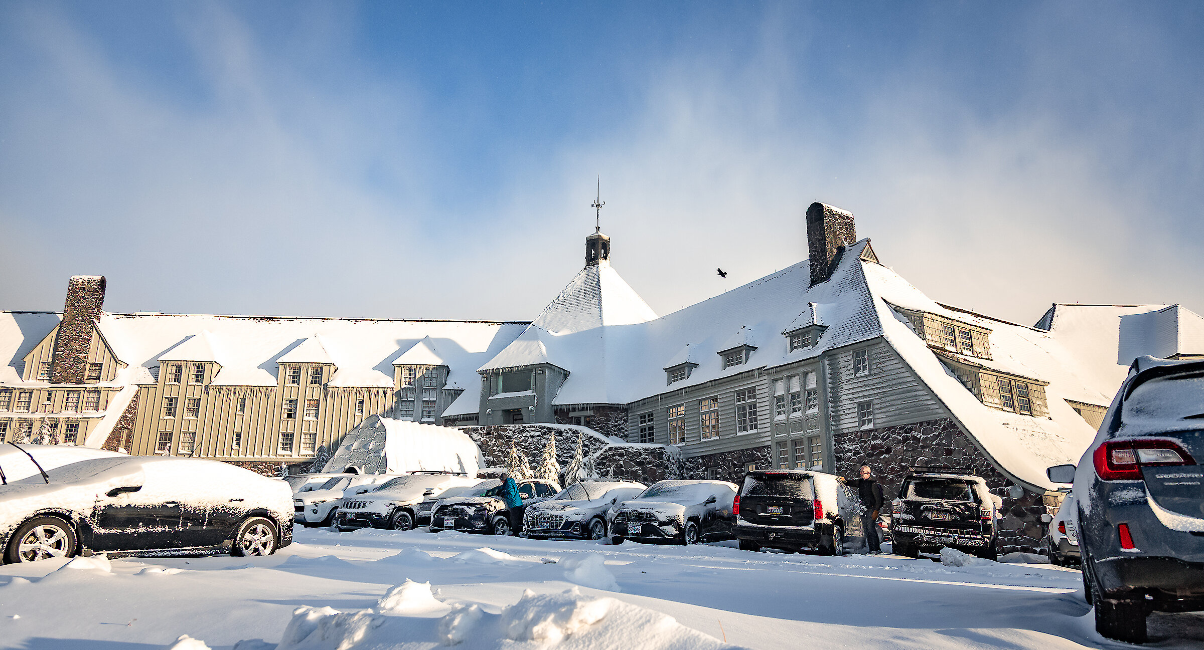 Cars parked in the snow in front of Timberline Lodge