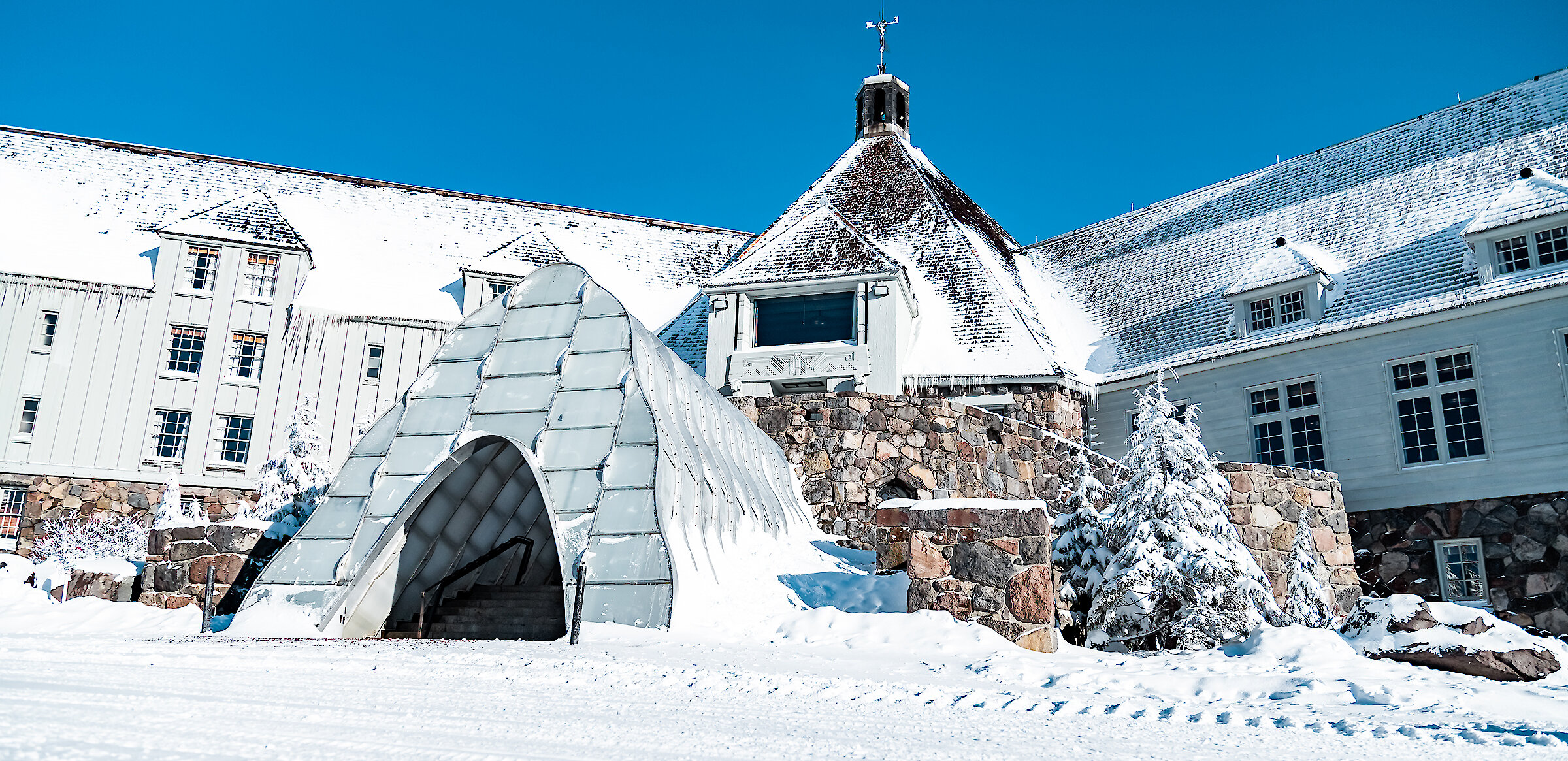 Timberline Lodge pictured in the early winter with the snow tunnel entrance welcoming guests to enter.