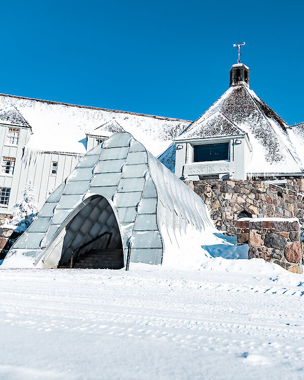Timberline Lodge pictured in the early winter with the snow tunnel entrance welcoming guests to enter.