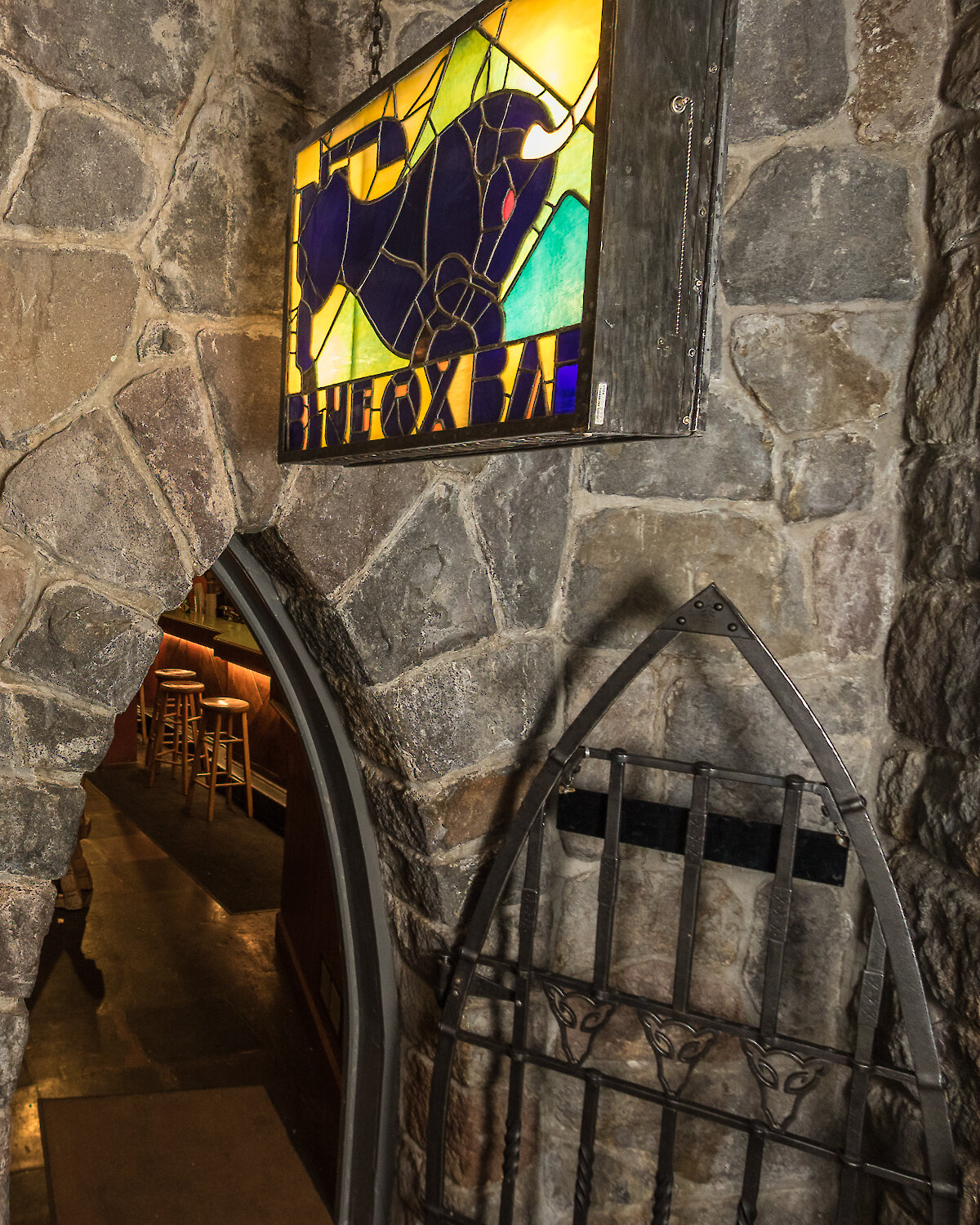 The sign and arched entrance of the Blue Ox Bar at Timberline Lodge.