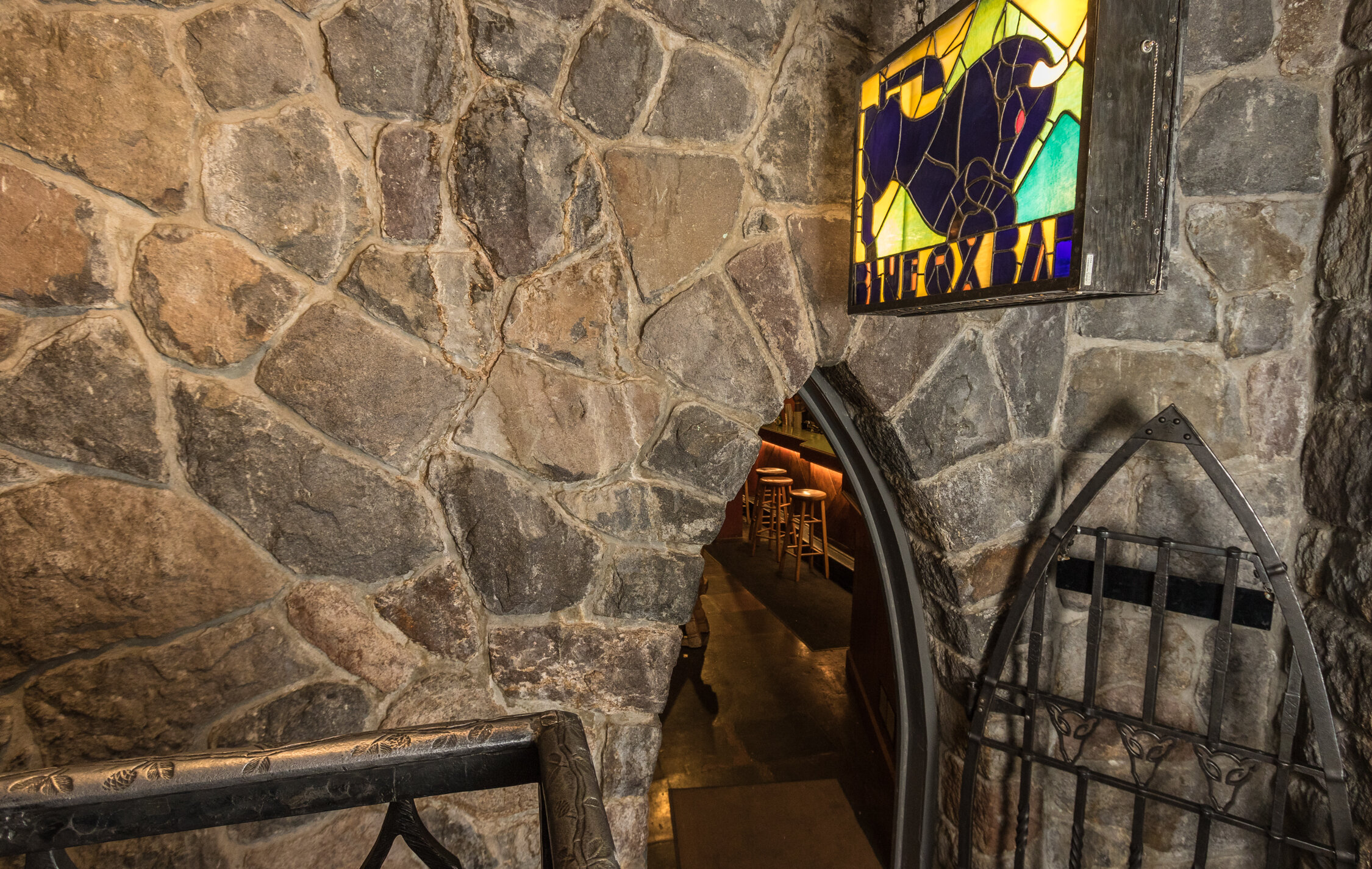 The sign and arched entrance of the Blue Ox Bar at Timberline Lodge.