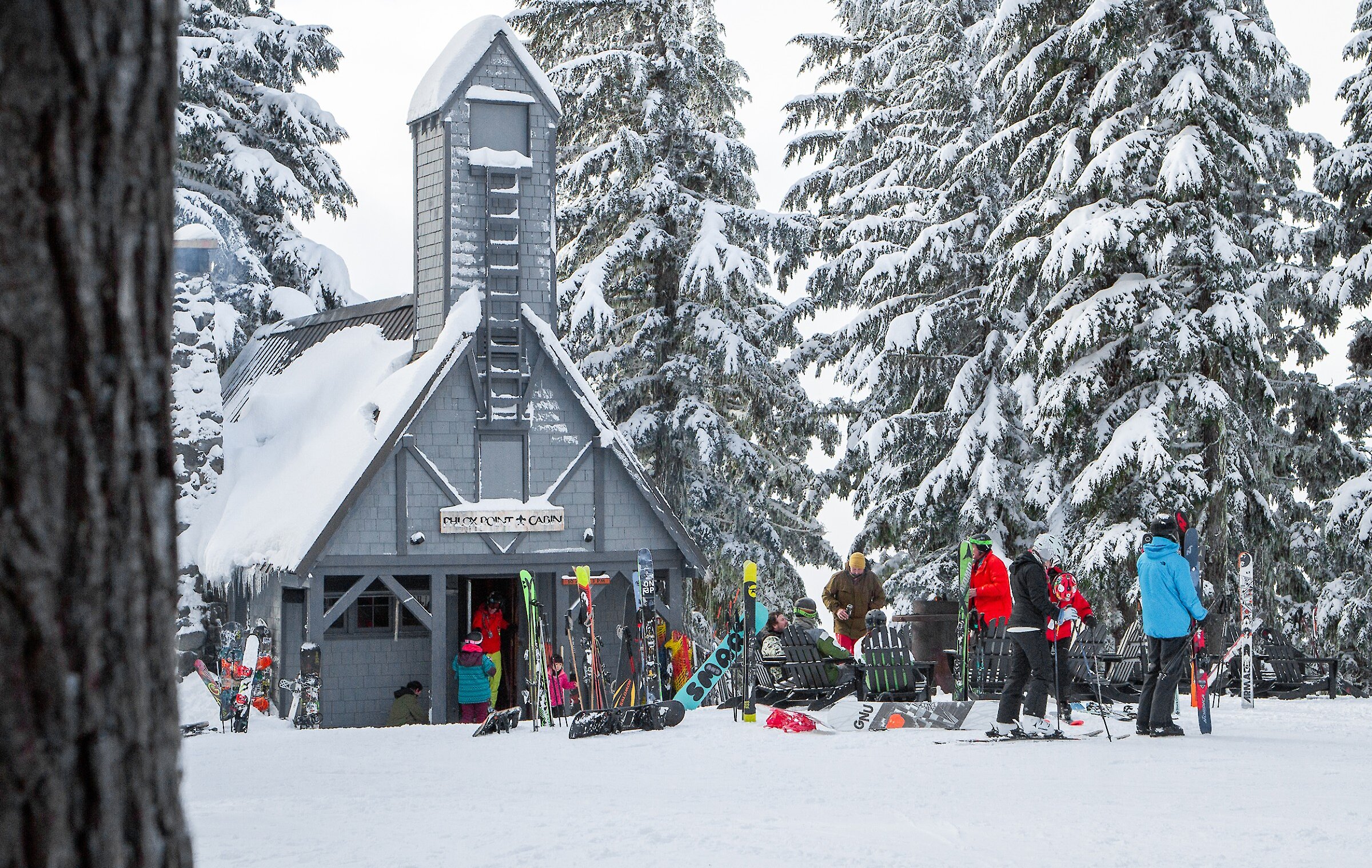 Timberline's Phlox Point Cabin pictured in the winter with skiers and snowboarders mingling outside
