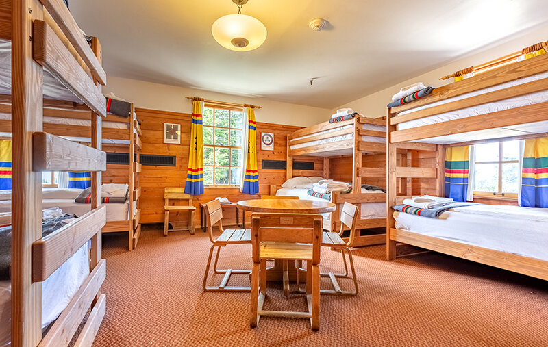 The Mary Gautreaux Room, the largest chalet at Timberline Lodge featuring a seating area and bunk beds