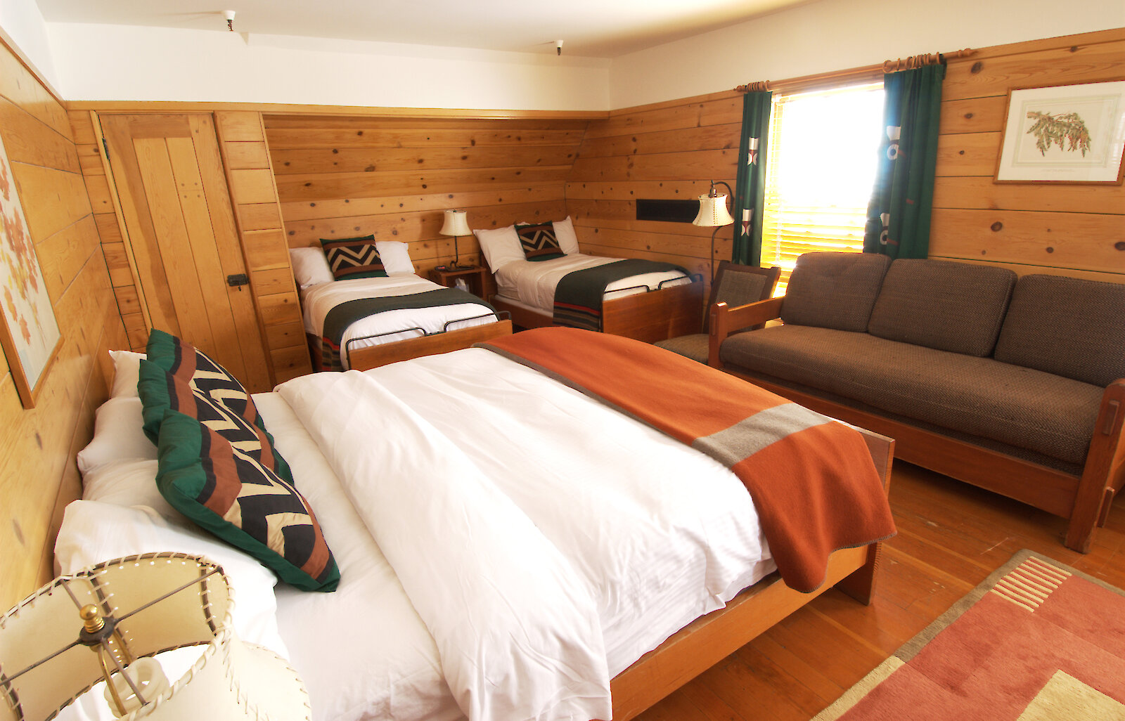 A Timberline Corner Room pictured with a queen bed and two twin beds