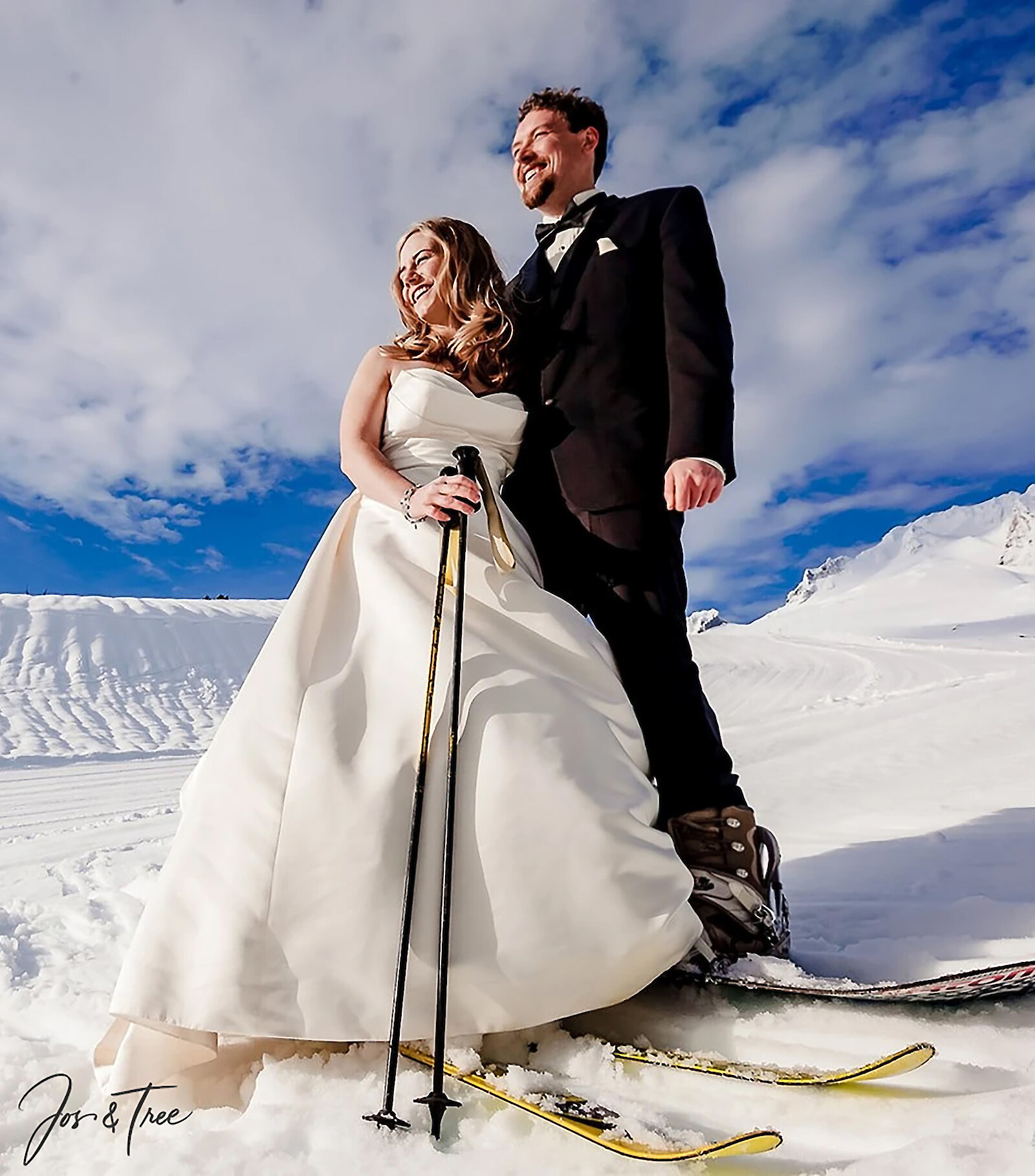 Wedding couple on skis posing on a snowy Mt. Hood above Timberline