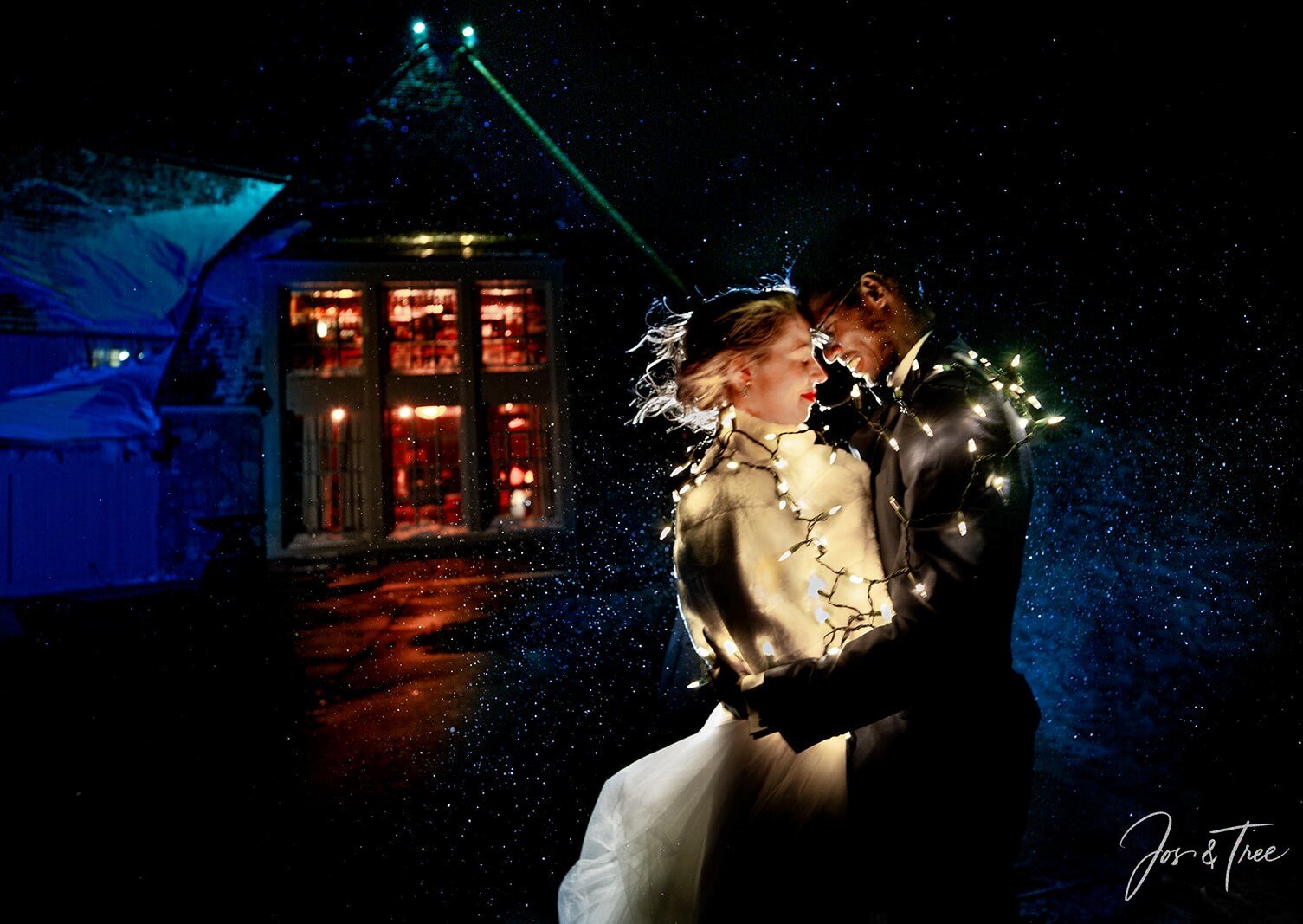 Wedding couple tangled in twinkly lights on the back patio at Timberline Lodge